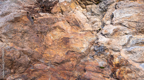 Rusted texture. Rusted background. Granite rocks. Colorful Rock background. Old Cracked Rusty Rough texture. Rock wall backdrop with rough red brown texture. Grunge Abstract Stone Surface.