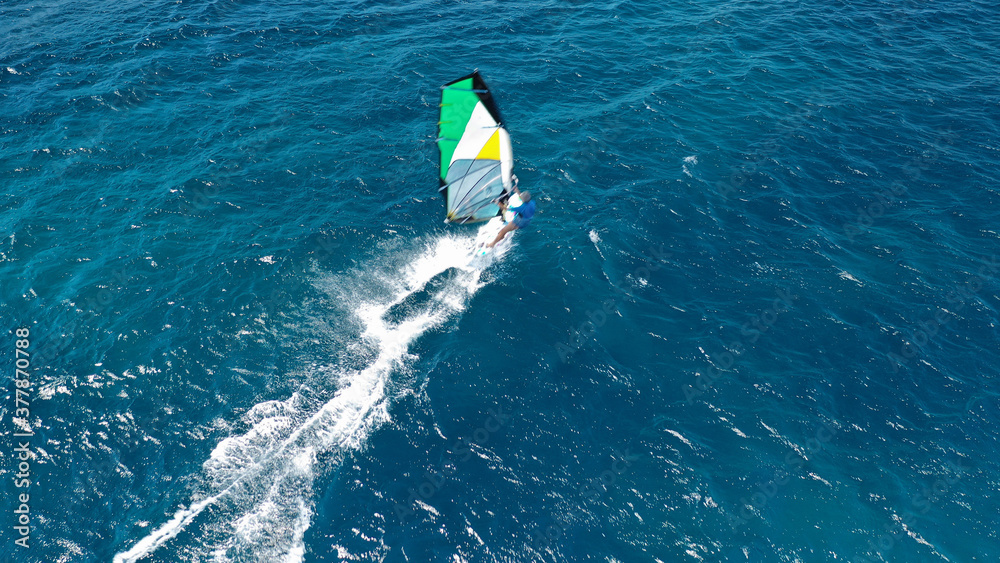 Aerial drone photo of wind surfer in open ocean deep blue sea on a windy morning