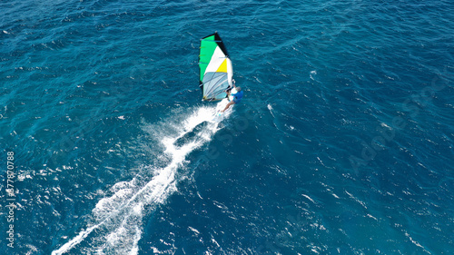 Aerial drone photo of wind surfer in open ocean deep blue sea on a windy morning