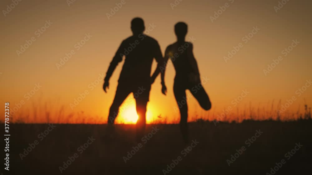 Blur effect, silhouette couple running at sunset. Outdoor sports. Blur effect, silhouette couple running at sunset. Outdoor sports.