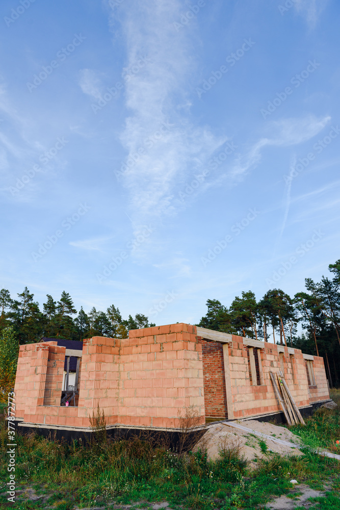 Interior of a Unfinished Red Brick House Walls under Construction without Roofing Interior of a Unfinished Red Brick House Walls under Construction without Roofing