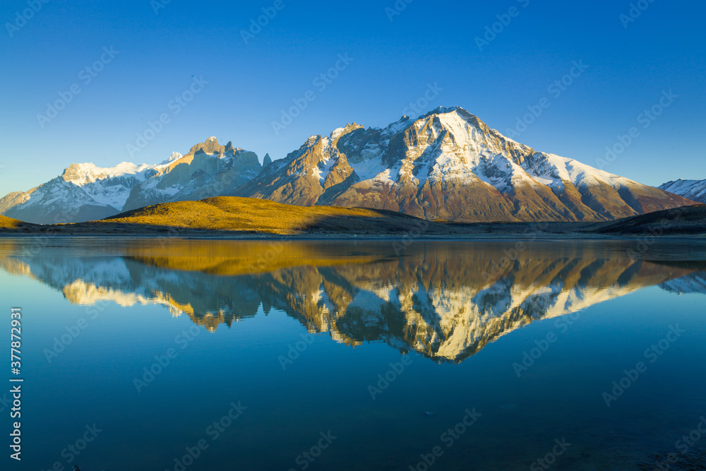 Perfect reflection of the Paine mountain range in Patagonia in a lake