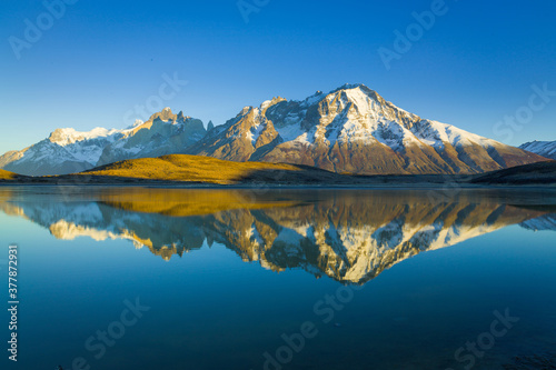 Perfect reflection of the Paine mountain range in Patagonia in a lake
