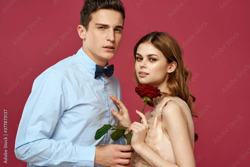 Lovers people with rose in hands on pink isolated background hug emotions happiness romance feelings Lovers people with rose in hands on pink isolated background hug emotions happiness romance feelings