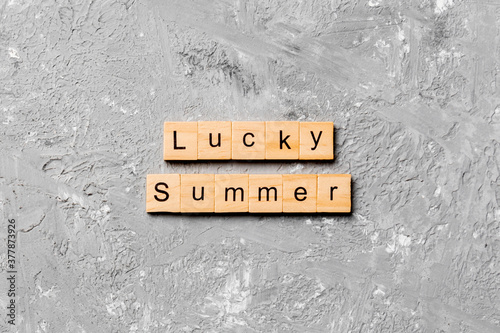 lucky Summer word written on wood block. lucky Summer text on cement table for your desing, concept
