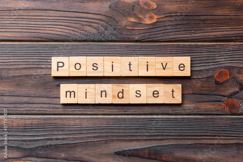 positive mindset word written on wood block. positive mindset text on cement table for your desing, concept photo