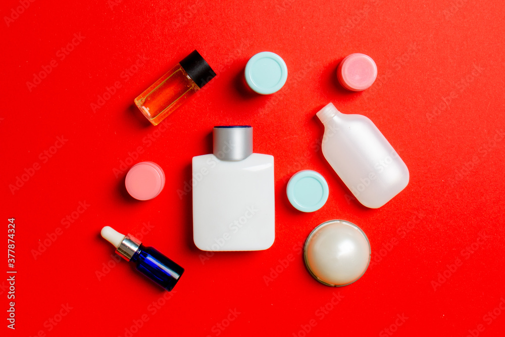 Cosmetics SPA branding mock-up, top view with copy space. set of tubes and jars of cream flat lay on colored background Cosmetics SPA branding mock-up, top view with copy space. set of tubes and jars of cream flat lay on colored background