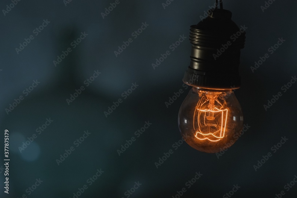 Hanging old light bulb turning on
