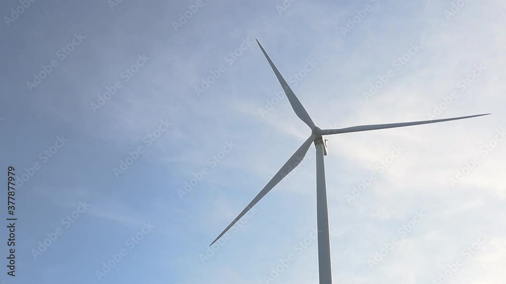 Close-up wind turbines or wind energy converter in sunny day with blue sky and white clouds.Renewable energy production for green ecological world. Close-up wind turbines or wind energy converter in sunny day with blue sky and white clouds.Renewable energy production for green ecological world.