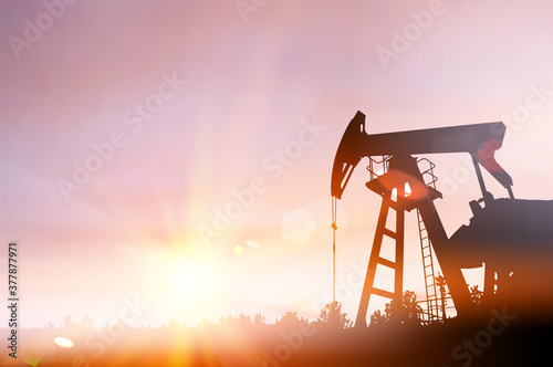 Darck silhoutte of oil rig and pumps during sunset