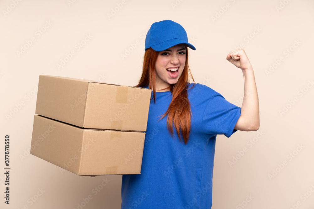 Young teenager delivery girl over isolated background making strong gesture Young teenager delivery girl over isolated background making strong gesture