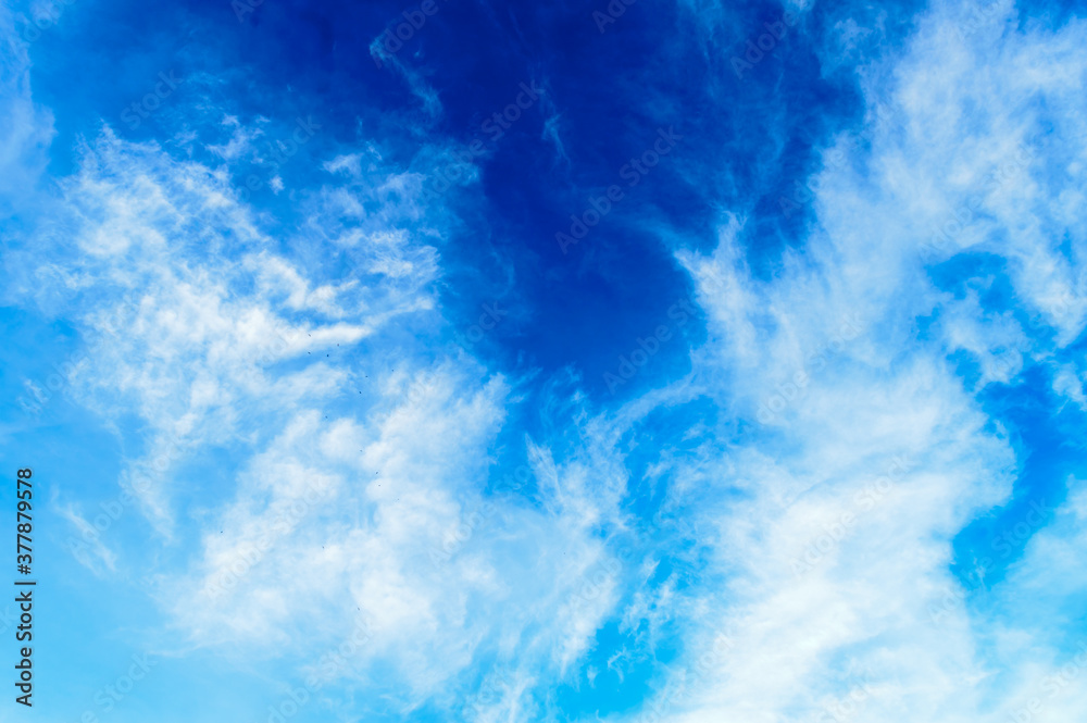 Blue sky background. Cloudy blue sky. Blue sky Abstract background with Dramatic tiny clouds floating. Fluffy Cloud Texture From A Perfect Cloudy spring time of day.