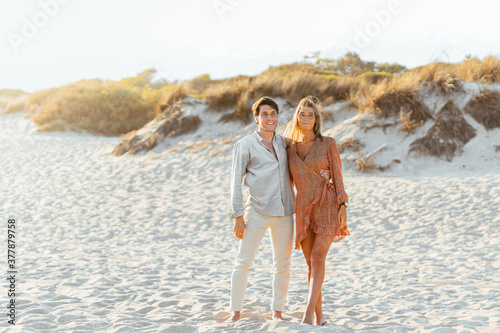 Happy couple enjoying the sunset on the beach