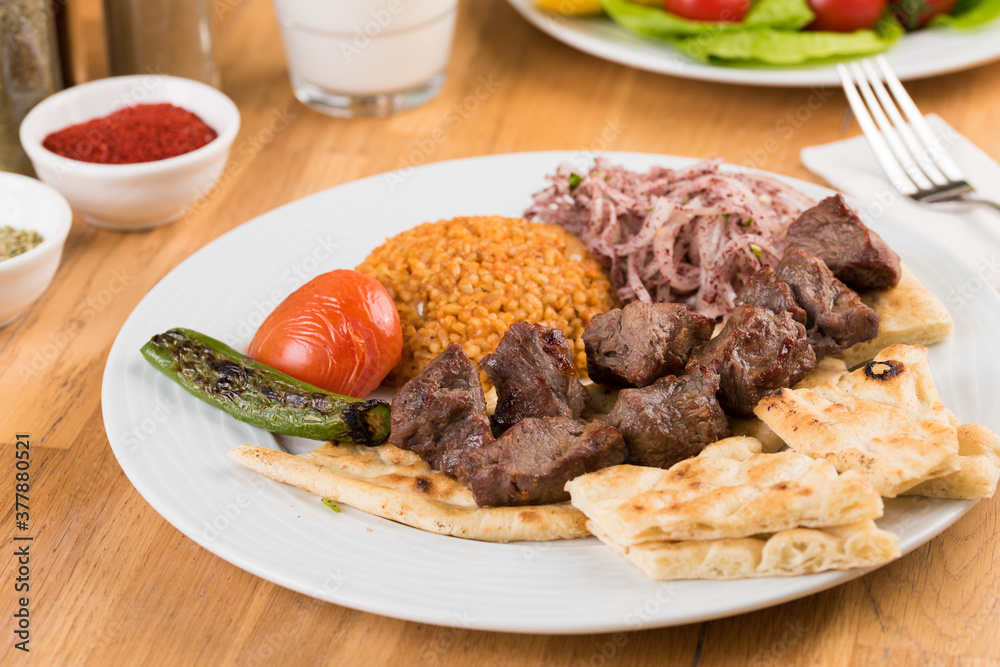 Traditional lamb skewers kebab with bulgur pilaf. Traditional lamb skewers kebab with bulgur pilaf.