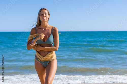 Beautiful latin girl enjoying sunbathing at beach