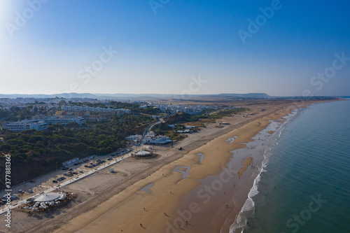 Fototapeta Naklejka Na Ścianę i Meble -  La Fontanilla beach near Conil de la frontera seen from above in a quiet summer morning