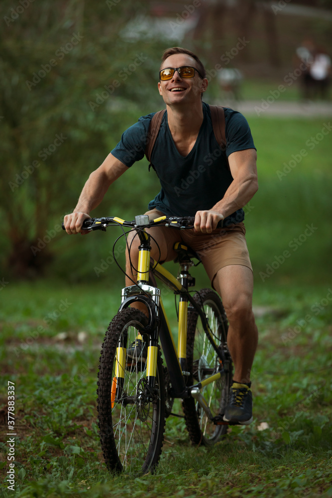 Young man cycling on bicycle in the public park Young man cycling on bicycle in the public park