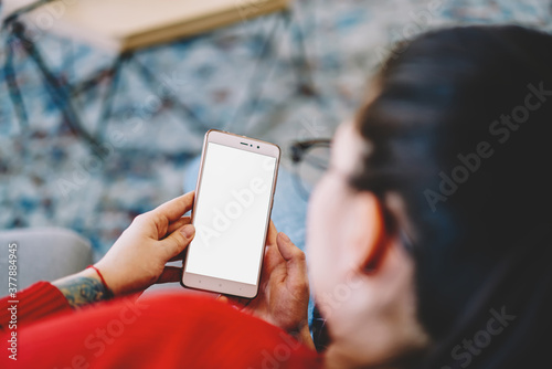 Woman browsing mobile phone at home