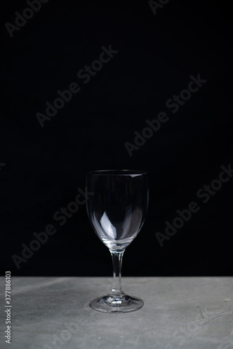 Wine glass on bar in the dark, Lonely in the dark concept.