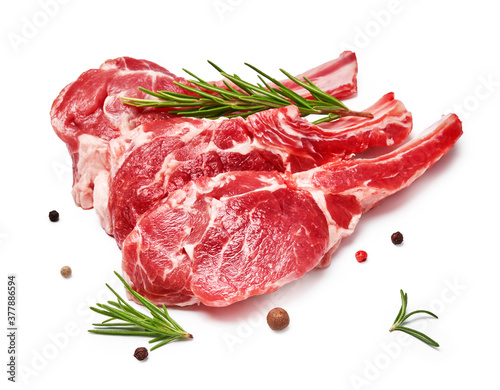 Three pieces of mutton meat with herbs and mixed peppers isolated on white background. Mutton steaks with rosemary. photo