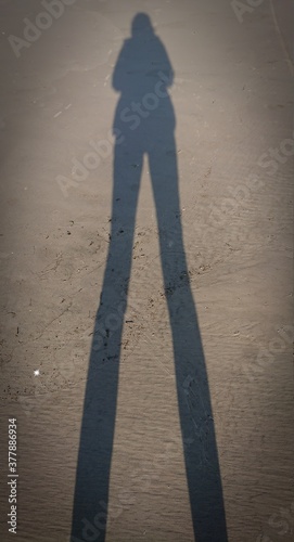 Silhouette of a person walking on the street