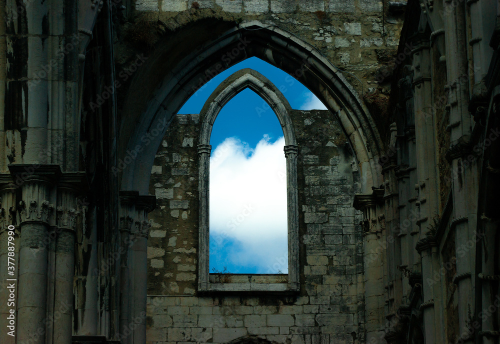 Ruins of a castle, from the broken window you can see a beautiful sky with clouds