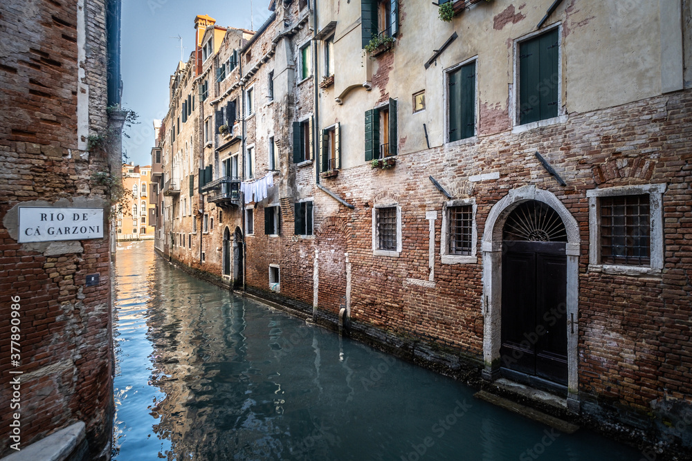 Streets of Venice with a typical waterl canal during a sunny day, Italy