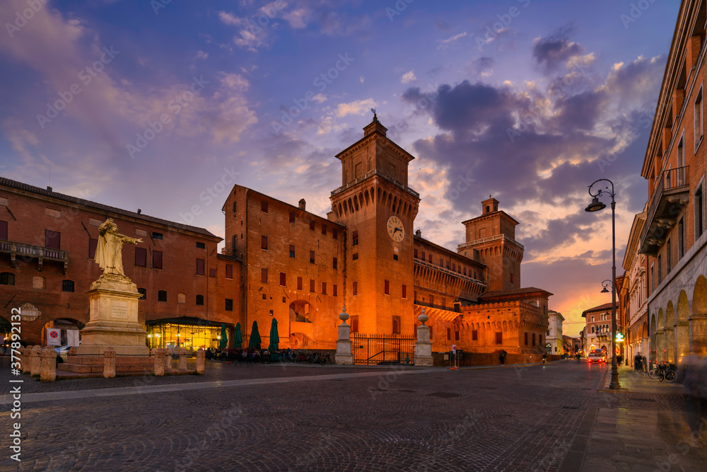 Castle Estense (Castello Estense) and piazza Savonarola and monumet to Savonarola in Ferrara, Emilia-Romagna, Italy. Ferrara is capital of the Province of Ferrara