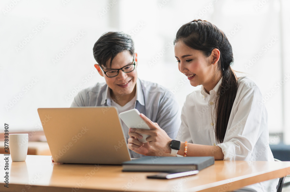 Asian business people man and woman conference talking and working with laptop together. Young couple work at home. Asian business people man and woman conference talking and working with laptop together. Young couple work at home.