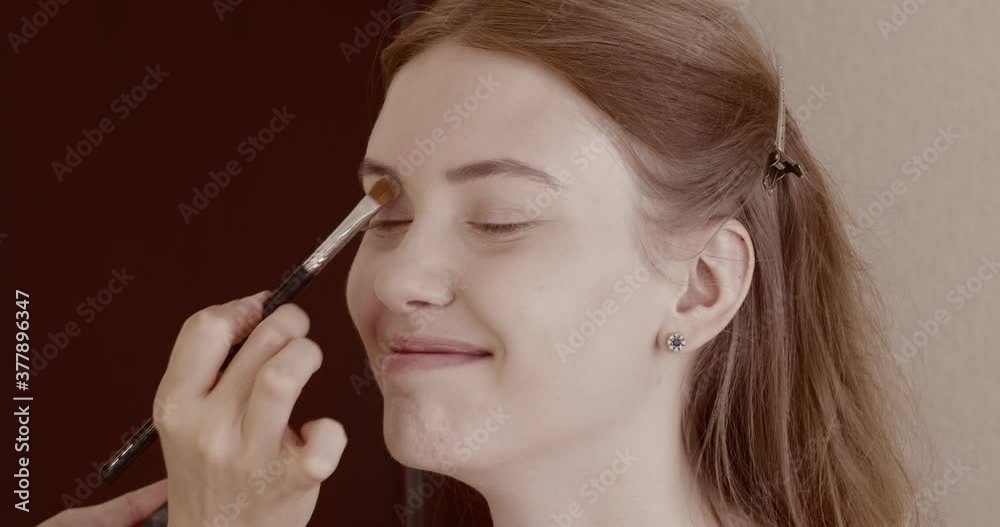 Makeup is applied to a beautiful young girl in the salon. Makeup is applied to a beautiful young girl in the salon.