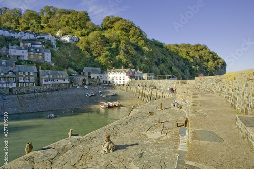 Clovelly is a harbour village in the Torridge district of Devon, England. Its steep pedestrianised cobbled main street, donkeys and views over the Bristol Channel attract numerous tourists. photo