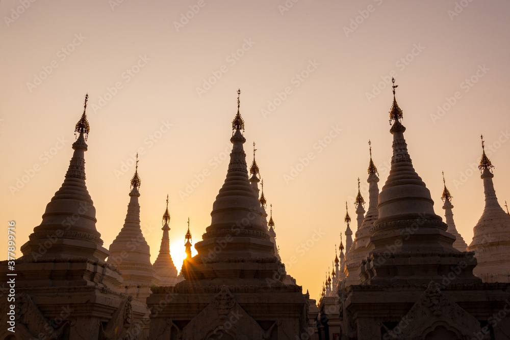 White stupas of Sanda Muni Pagoda at sunset in Mandalay, Burma Myanmar