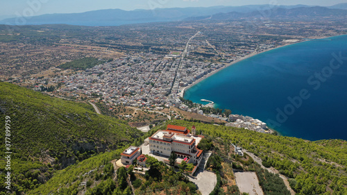 Aerial drone photo of iconic monastery Prophet Elias or Profitis Ilias built on top of a cliff overlooking Loutraki town, Corinthian bay, Greece photo