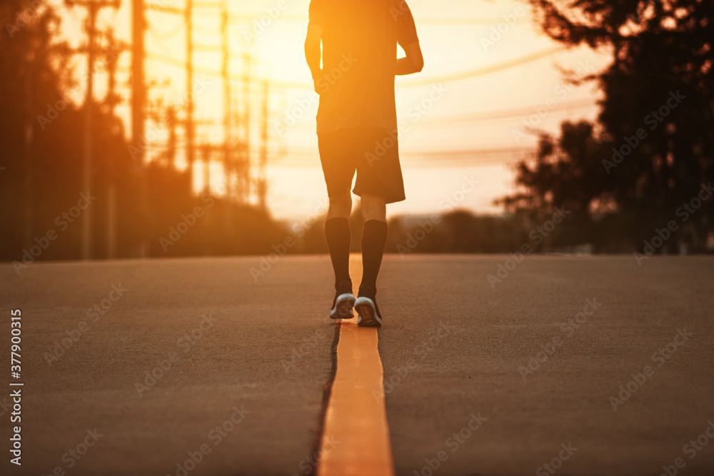 Blurry subject Man running on road sunset background