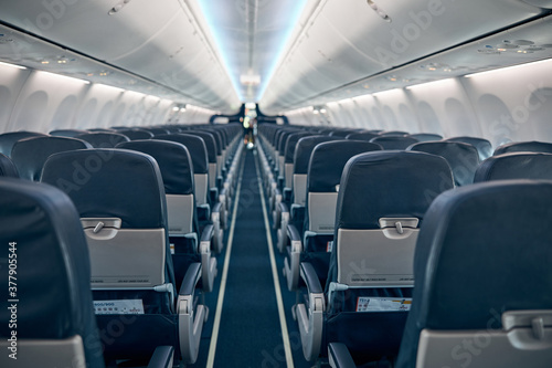 Airline passenger chairs and aisle in airplane cabin