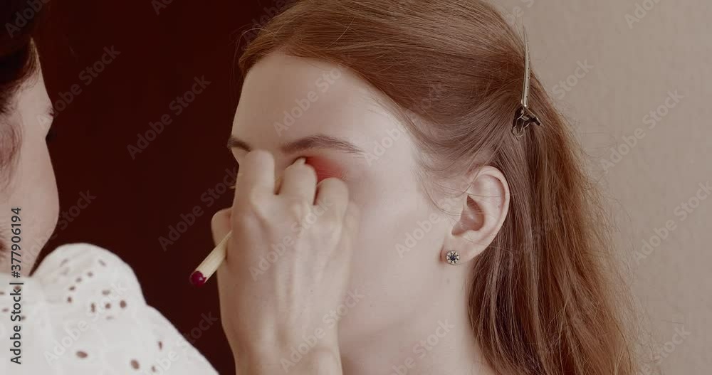 Makeup is applied to a beautiful young girl in the salon. Makeup is applied to a beautiful young girl in the salon.
