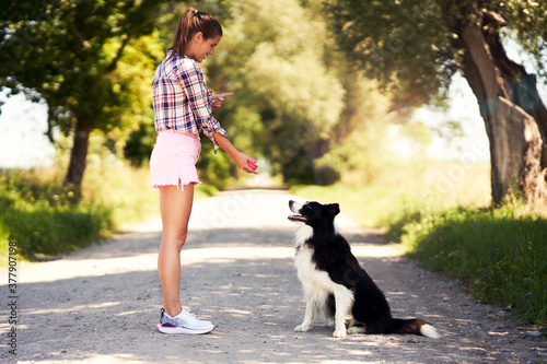 Portrait of happy female strolling with her pet at leisure