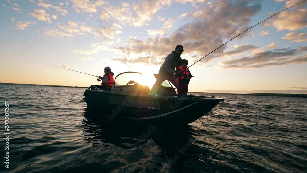 A father is helping his kids with fishing from a boat