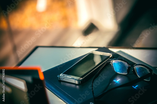 Smartphone and glasses placed on the table
