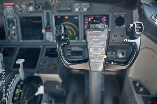 Airplane cockpit with control column and flight displays