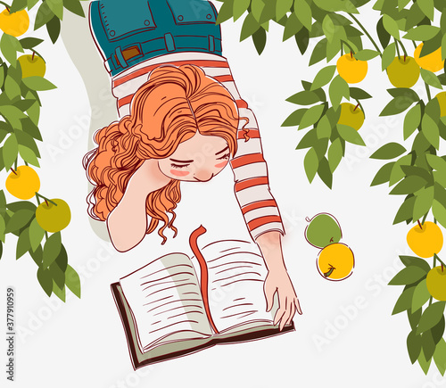 Cute girl reads a book in garden