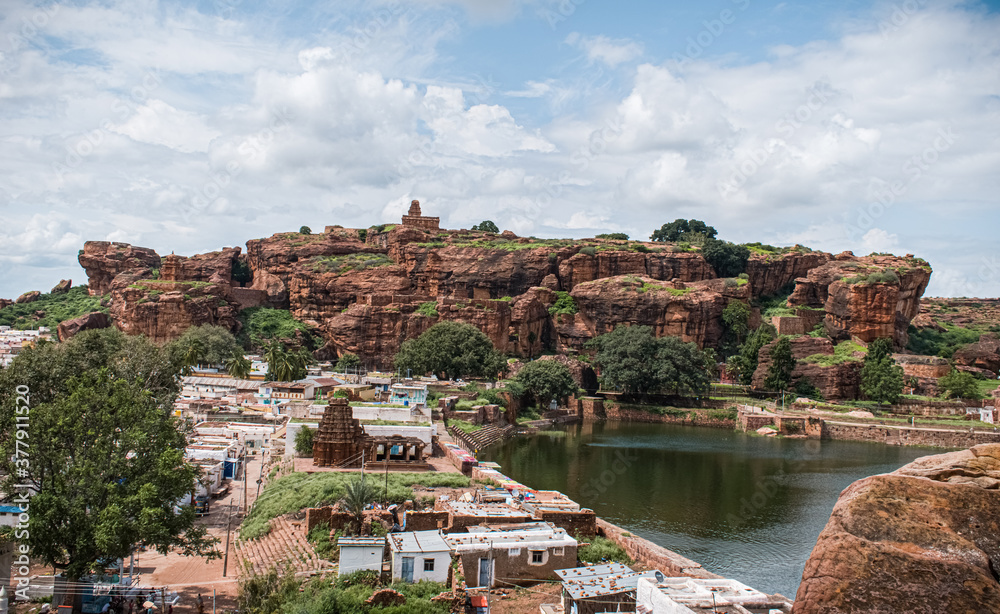 Landscape view of badami templees and caves on red sandstone hills.