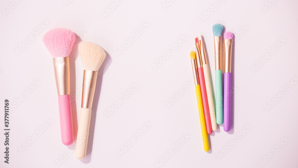 Make up brushes with powder on white background