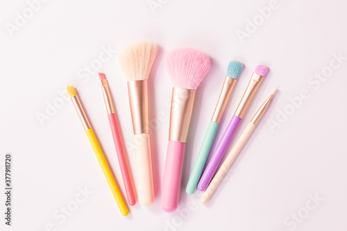 Make up brushes with powder on white background
