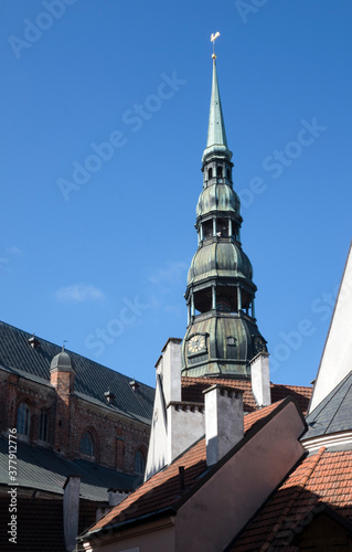 Bell tower steeple of St. Peter's Church with weather vane "golden cockerel" in Riga, Latvia...