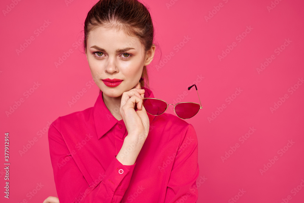 Fashion woman in pink shirt with glasses in hands on isolated background cropped view Fashion woman in pink shirt with glasses in hands on isolated background cropped view