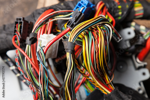 A cable of matted wires of different colors with connectors in the electrical wiring of the car. Internet line in the work of the provider.