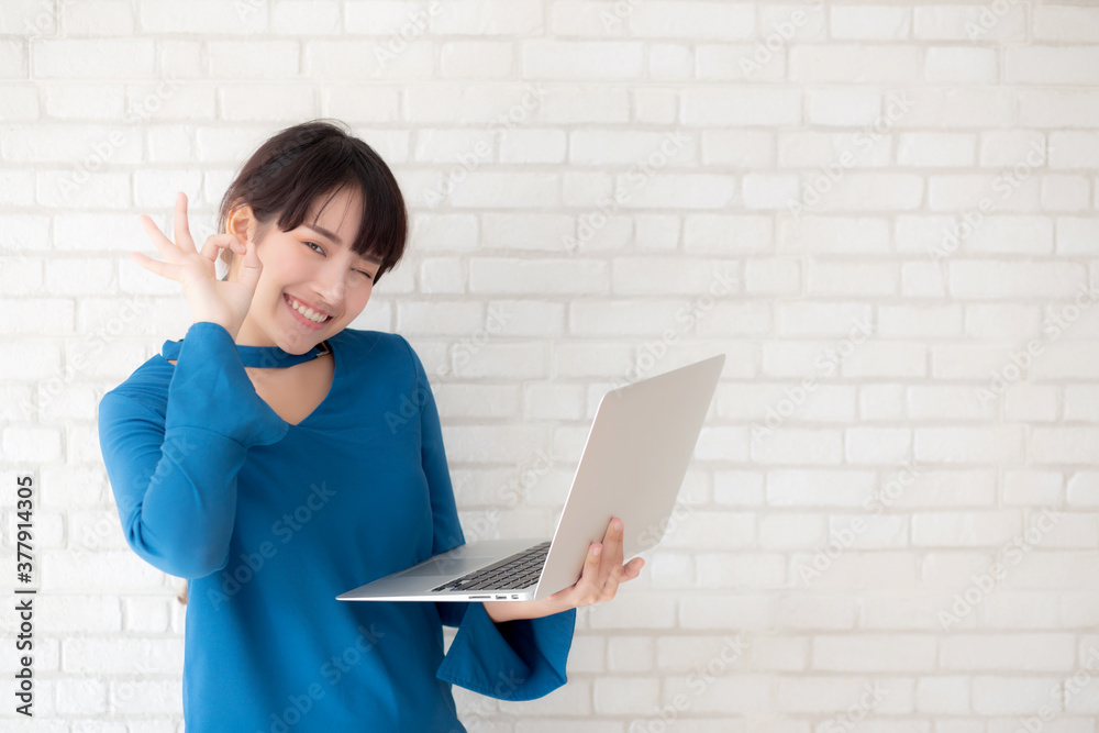 Beautiful freelance young asian woman confident using laptop computer online internet with success, blogger girl expression of excited with achievement from work and having proud in triumph. Beautiful freelance young asian woman confident using laptop computer online internet with success, blogger girl expression of excited with achievement from work and having proud in triumph.