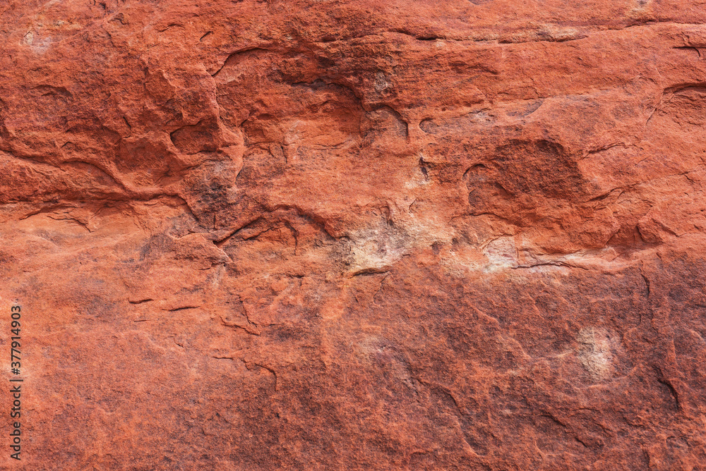 Textured surface of red stone.