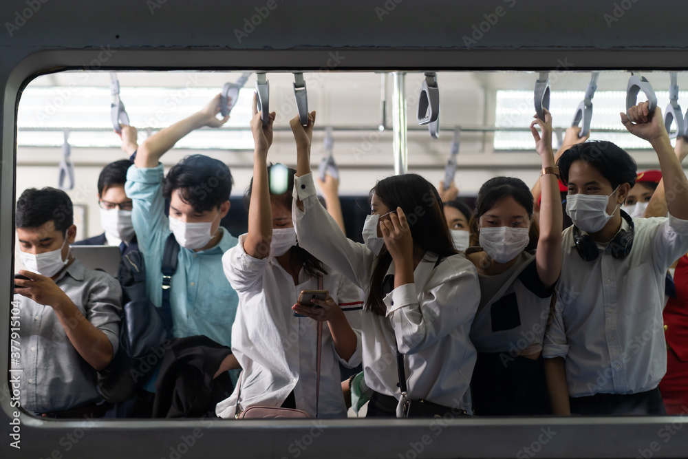 Crowd of passengers on Urban Public Transport Metro. .Asian people go to work by public transport. Face Mask protection against virus. Covid-19, coronavirus pandemic Crowd of passengers on Urban Public Transport Metro. .Asian people go to work by public transport. Face Mask protection against virus. Covid-19, coronavirus pandemic